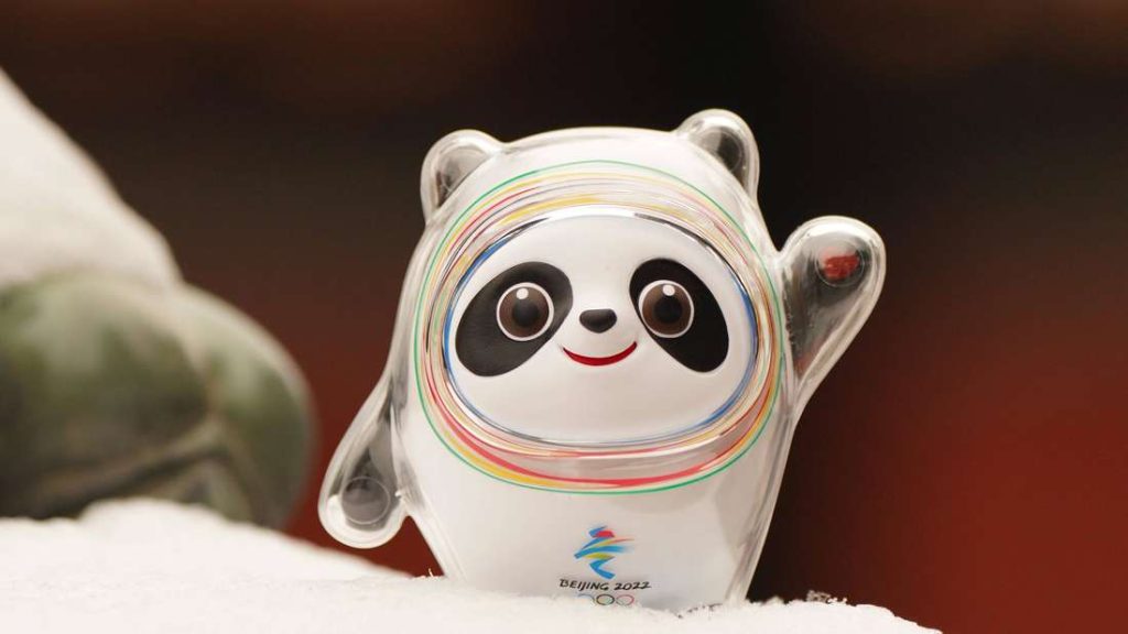 A Bing Dwen Dwen mascot raising his hand to greet
