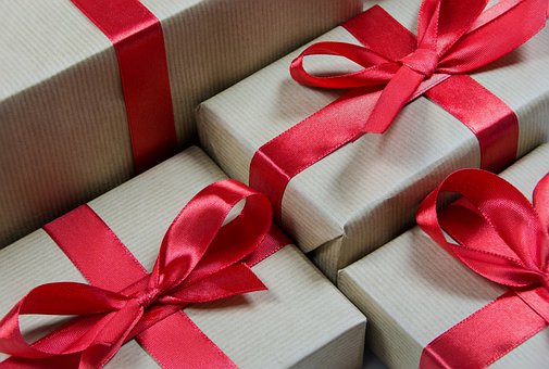Several gifts beautifully wrapped with red ribbons